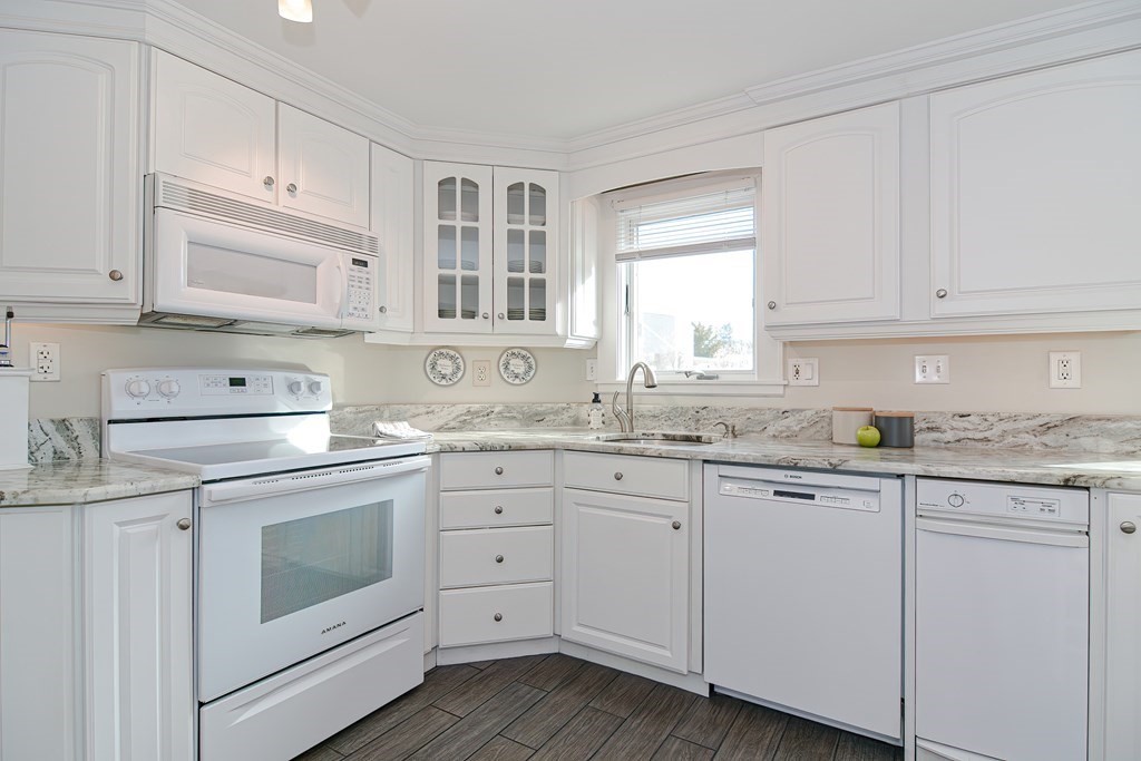 35 Colasanti Road Weymouth, MA 02191 - Photo 11 of 39 a kitchen with granite countertop white cabinets and white appliances