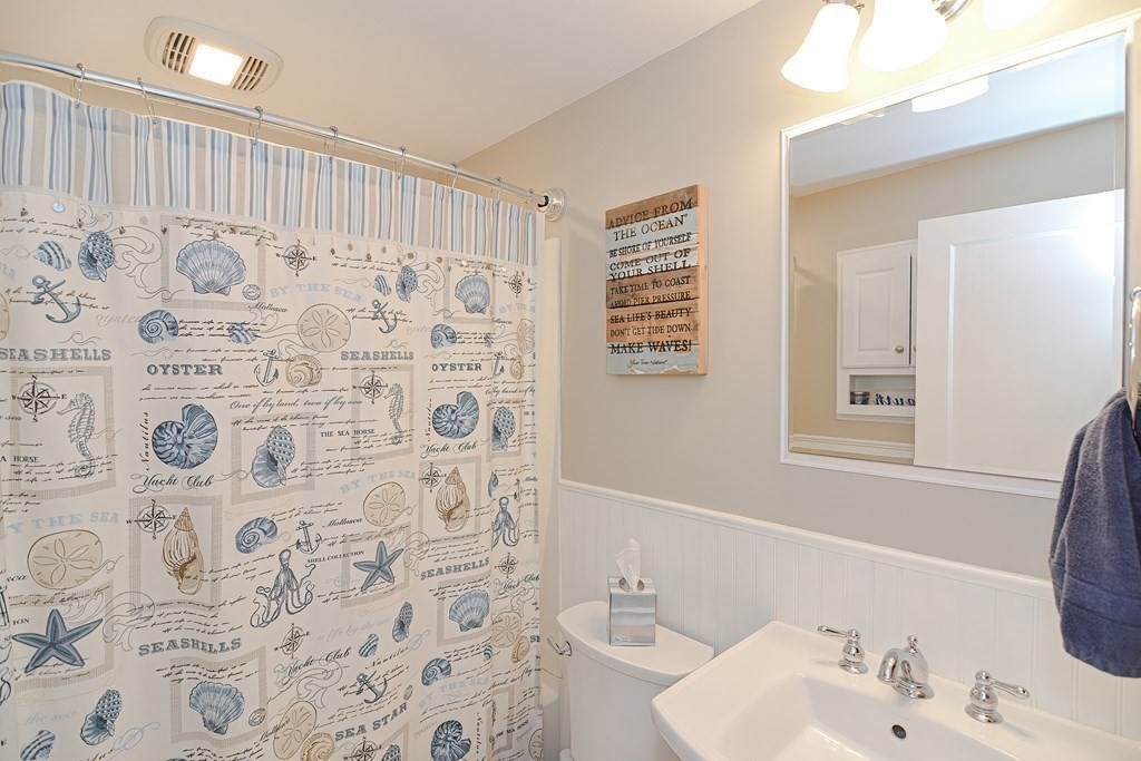 35 Colasanti Road Weymouth, MA 02191 - Photo 18 of 39 a bathroom with a sink a toilet and a mirror