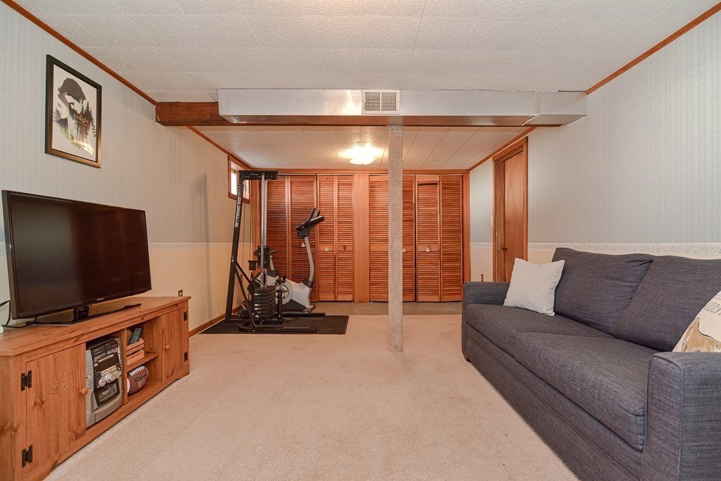 35 Colasanti Road Weymouth, MA 02191 - Photo 26 of 39 a living room with furniture and a flat screen tv