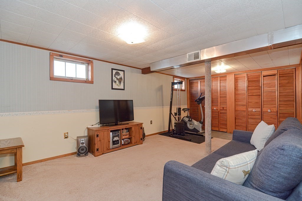 35 Colasanti Road Weymouth, MA 02191 - Photo 27 of 39 a living room with furniture and a flat screen tv