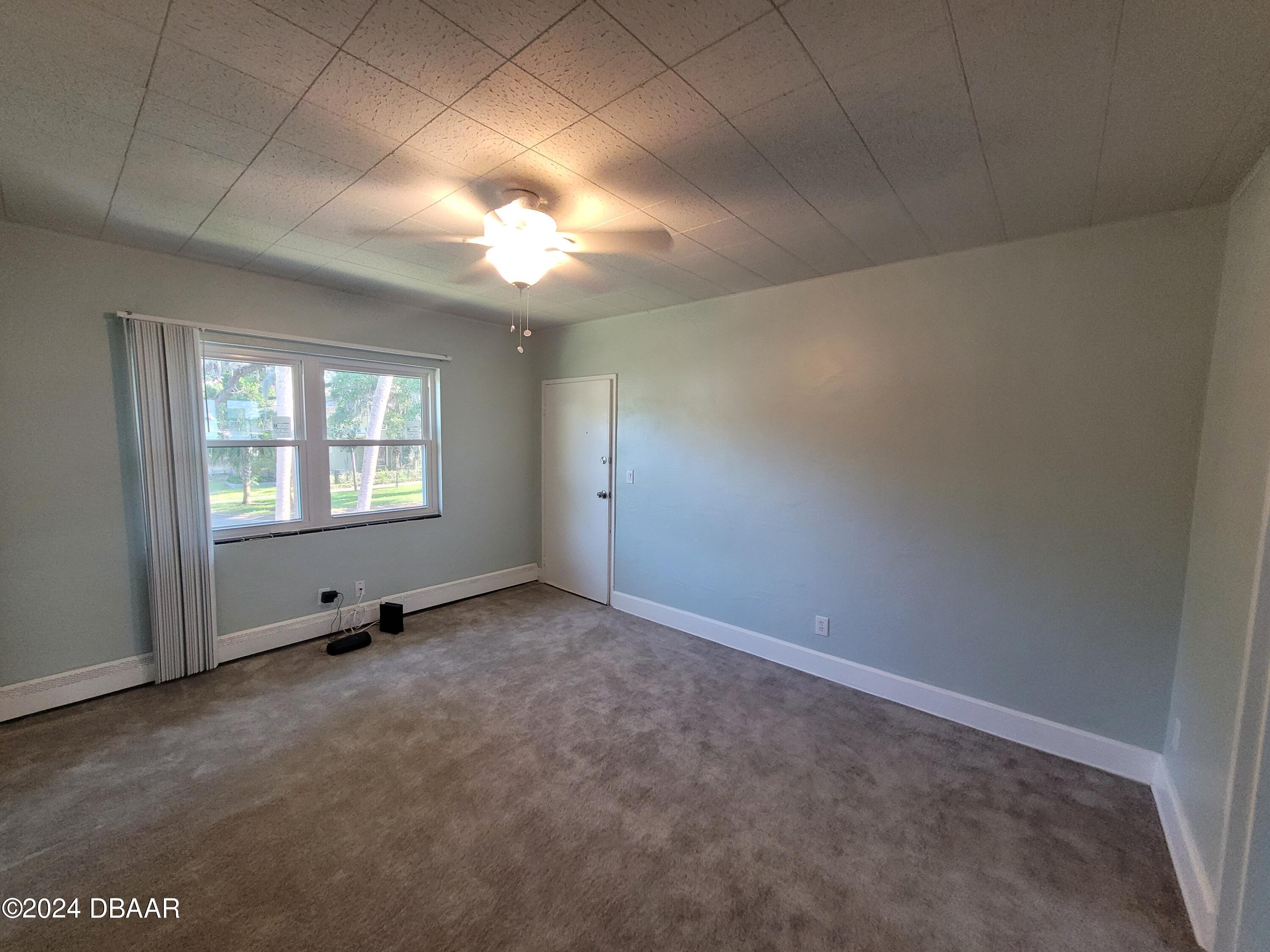 500 South Beach Street, Unit J4 Daytona Beach, FL 32114 - Photo 12 of 36 an empty room with windows