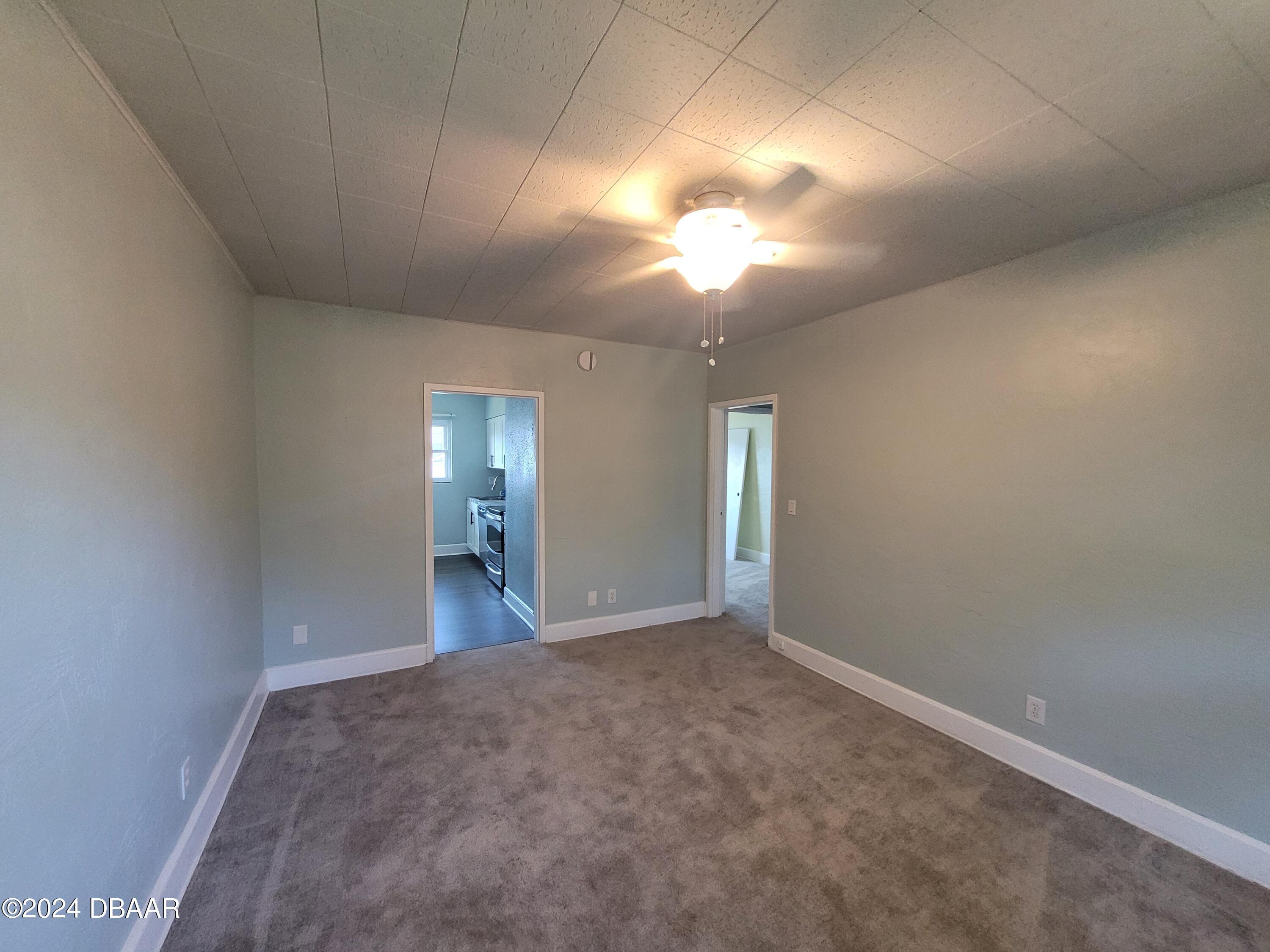 500 South Beach Street, Unit J4 Daytona Beach, FL 32114 - Photo 13 of 36 an empty room with stairs and wooden floor