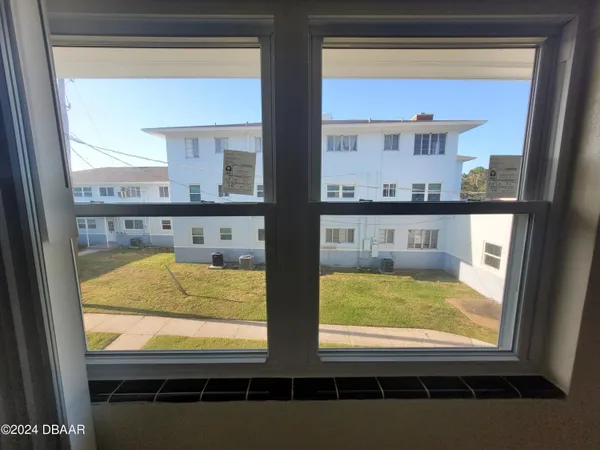 a view of a livingroom and a chandelier fan