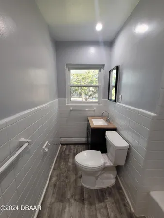 a white toilet sitting next to a bathroom sink and tub