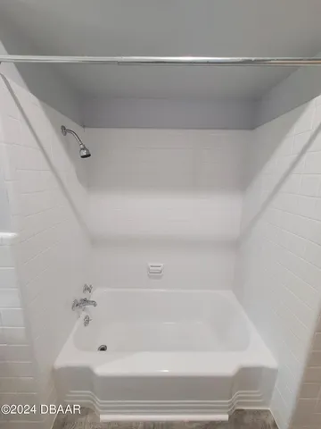 a view of a swimming pool with lawn chairs under an umbrella