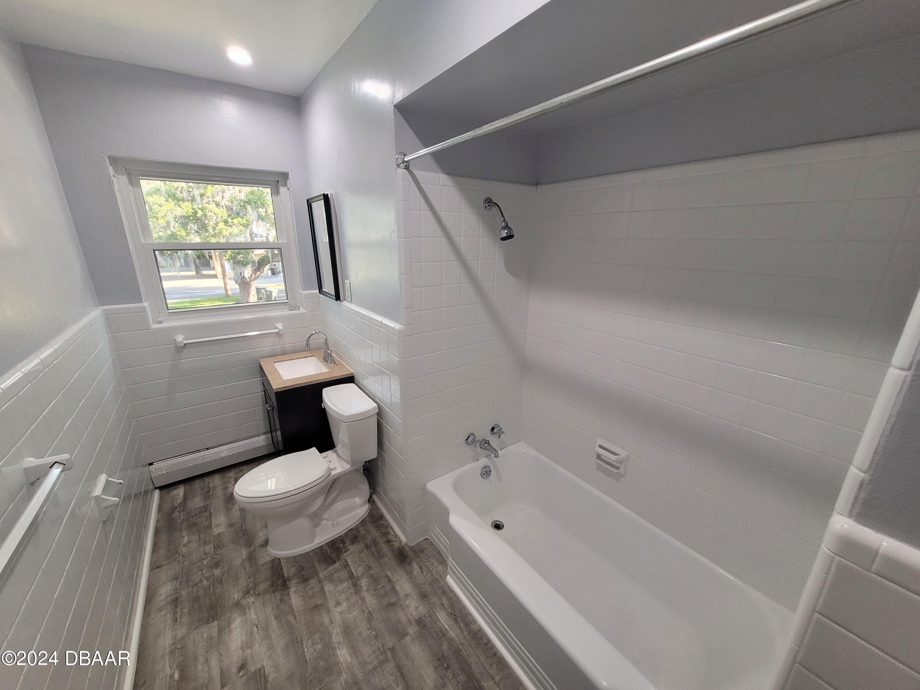 500 South Beach Street, Unit J4 Daytona Beach, FL 32114 - Photo 28 of 36 a white toilet sitting next to a bathroom sink and tub