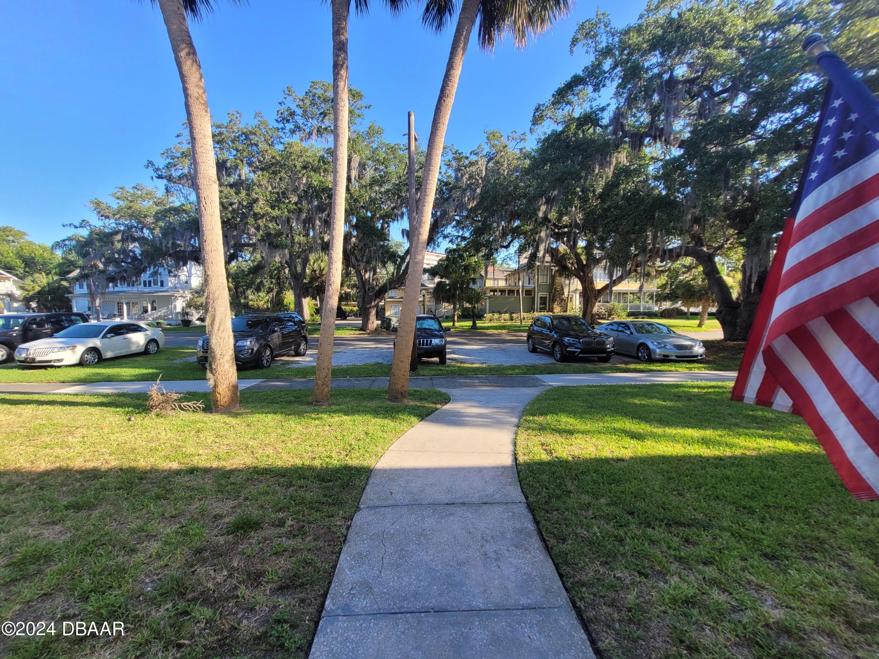 500 South Beach Street, Unit J4 Daytona Beach, FL 32114 - Photo 30 of 36 a view of a swimming pool with lawn chairs under an umbrella