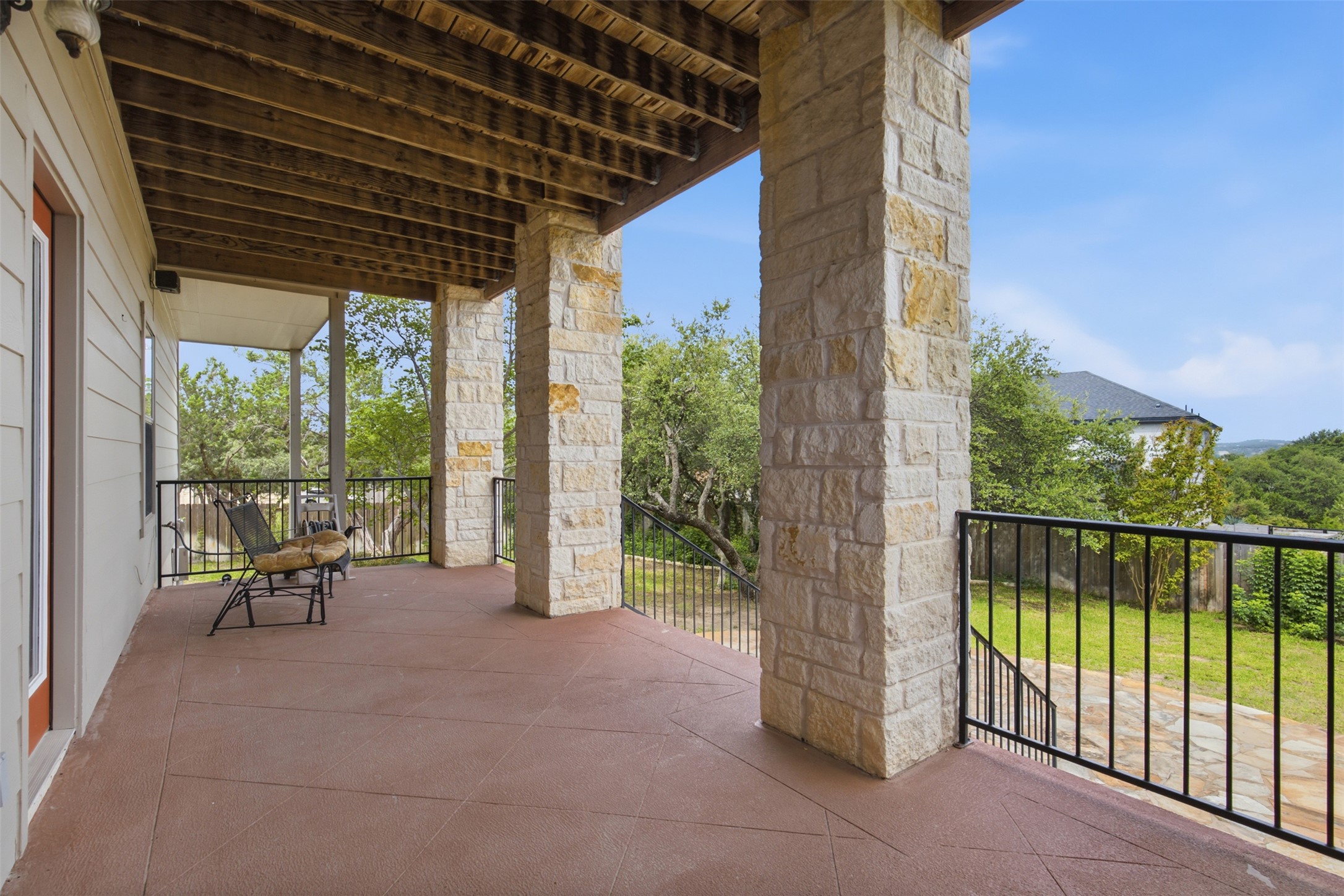 700 Augusta Circle Point Venture, TX 78645 - Photo 23 of 35 Backyard covered patio provides a serene outdoor living area, perfect for enjoying the surrounding natural landscape.