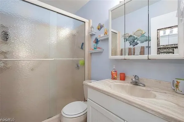 a bathroom with a sink a toilet and a shower curtain