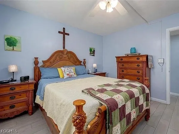 a bedroom with a bed and a chandelier