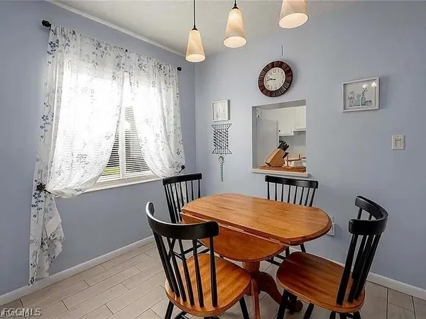 a view of a dining room with furniture window and wooden floor