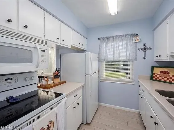 a kitchen with stainless steel appliances a refrigerator sink and cabinets