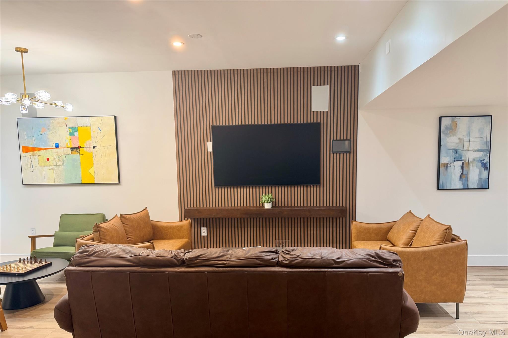 210 Pelham Road, Unit 5M New Rochelle, NY 10805 - Photo 15 of 26 a living room with furniture and a flat screen tv