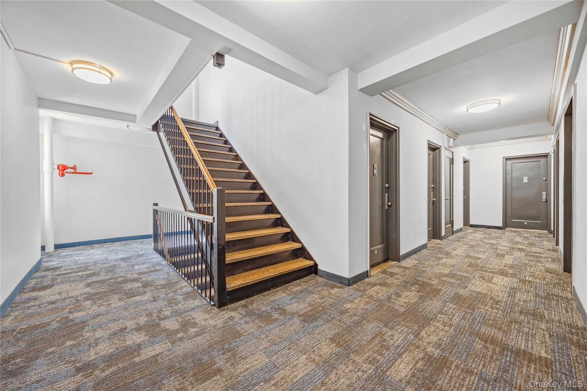 210 Pelham Road, Unit 5M New Rochelle, NY 10805 - Photo 9 of 26 a view of an empty room with stairs