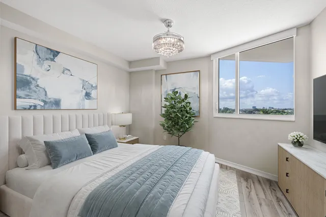 a bedroom with a large bed and a window