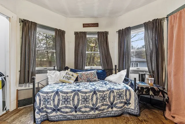 a bedroom with a large bed and a large window