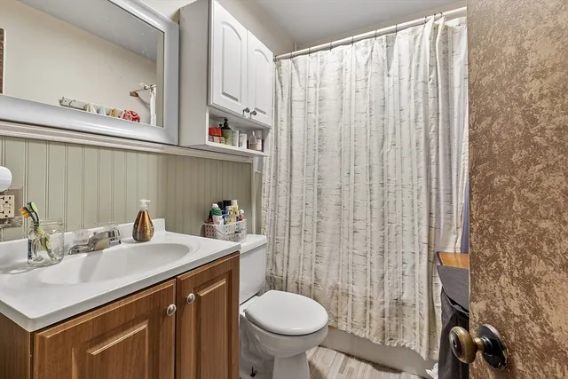 a bathroom with a sink a toilet and a mirror