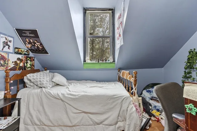 a bedroom with a bed and a window