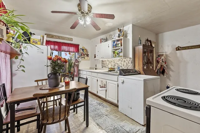 a kitchen that has a dining table and chairs