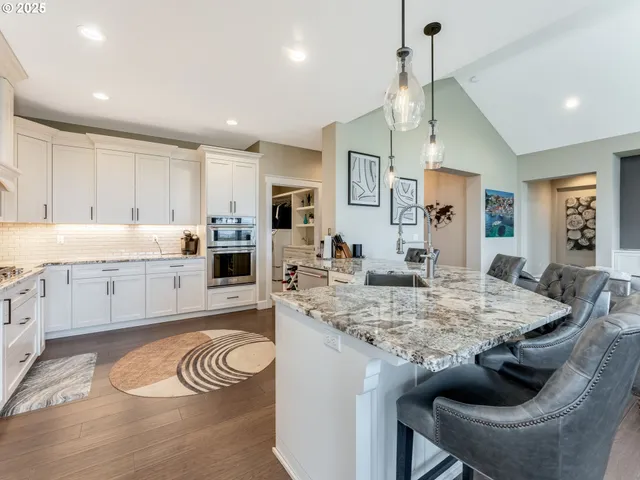 a kitchen with granite countertop kitchen island stainless steel appliances sink microwave and stove