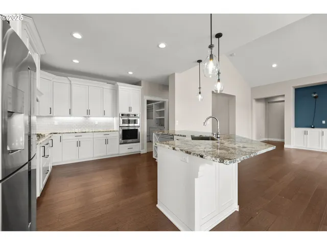a kitchen with stainless steel appliances granite countertop a sink stove and refrigerator