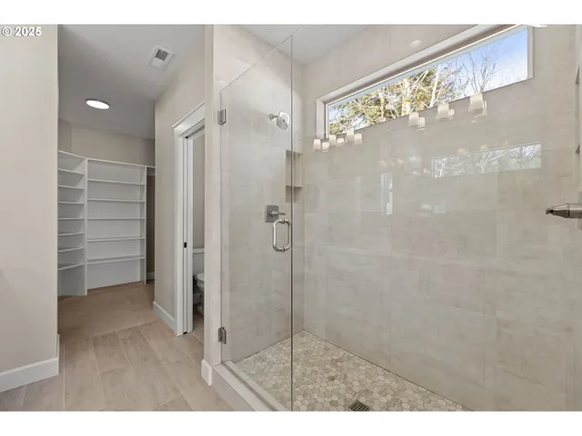 a bathroom with a shower and a sink