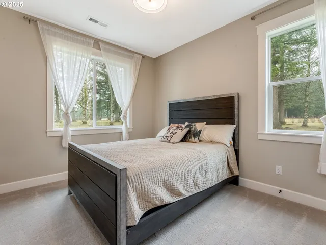 a bed sitting in a bedroom next to a window