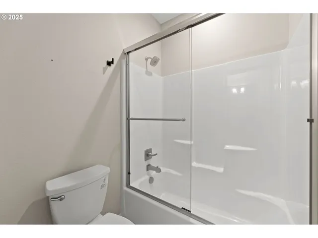 a bathroom with a shower and a toilet