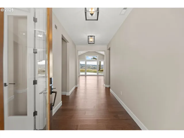 a view of a hallway view with wooden floor and furniture