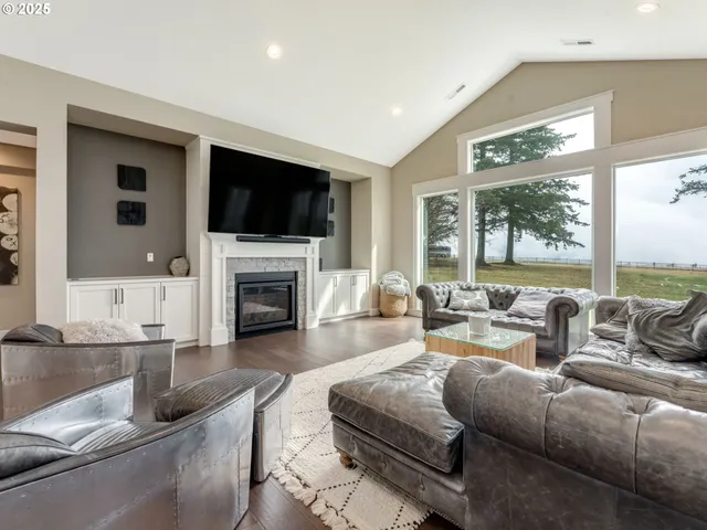 a living room with furniture fireplace and flat screen tv