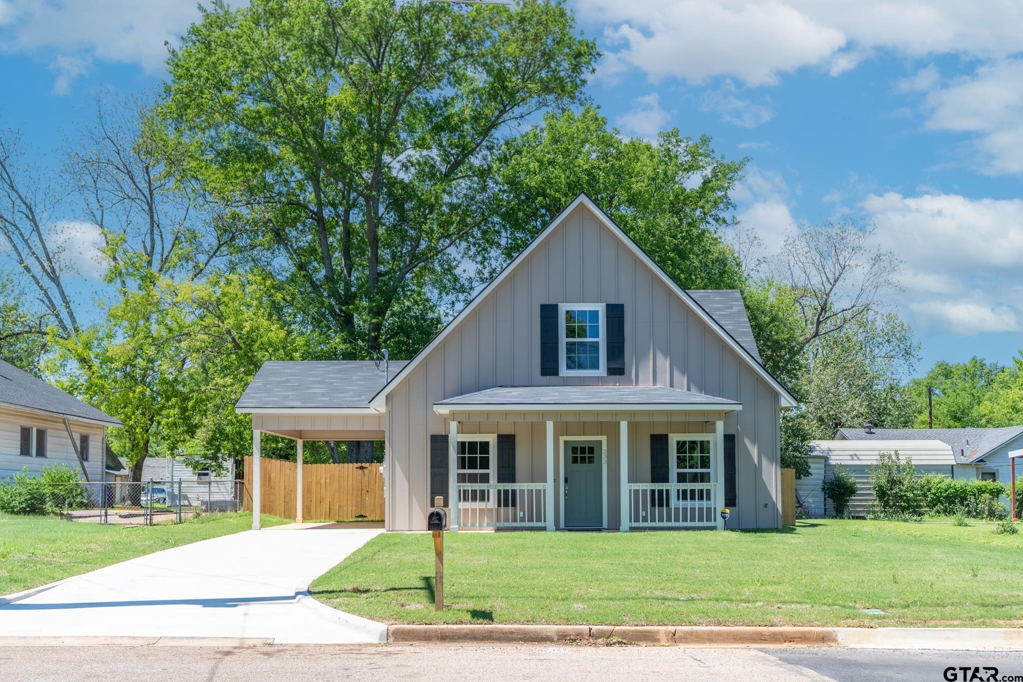 233 Harrison Street Longview, TX 75601 - Photo 4 of 44 a front view of a house with a yard