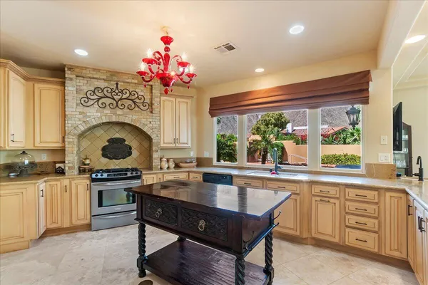 a kitchen with a stove a sink a counter space and dining table