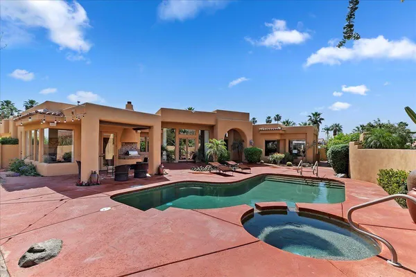 a view of a backyard with plants and patio