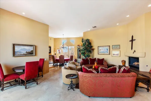 a living room with furniture a fireplace and a window