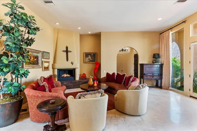 a living room with furniture fireplace and potted plant