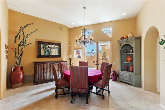 a view of a dining room with furniture and chandelier