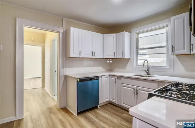 a kitchen with a sink stove and cabinets