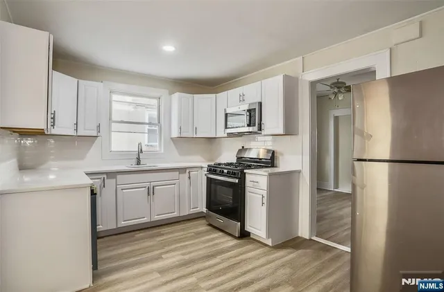 a kitchen with a refrigerator stove and sink
