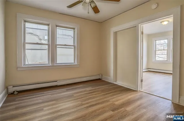 an empty room with windows and closet