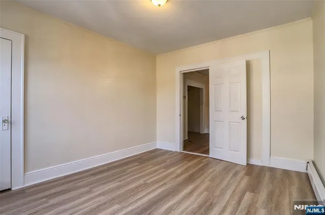 a view of an empty room and wooden floor