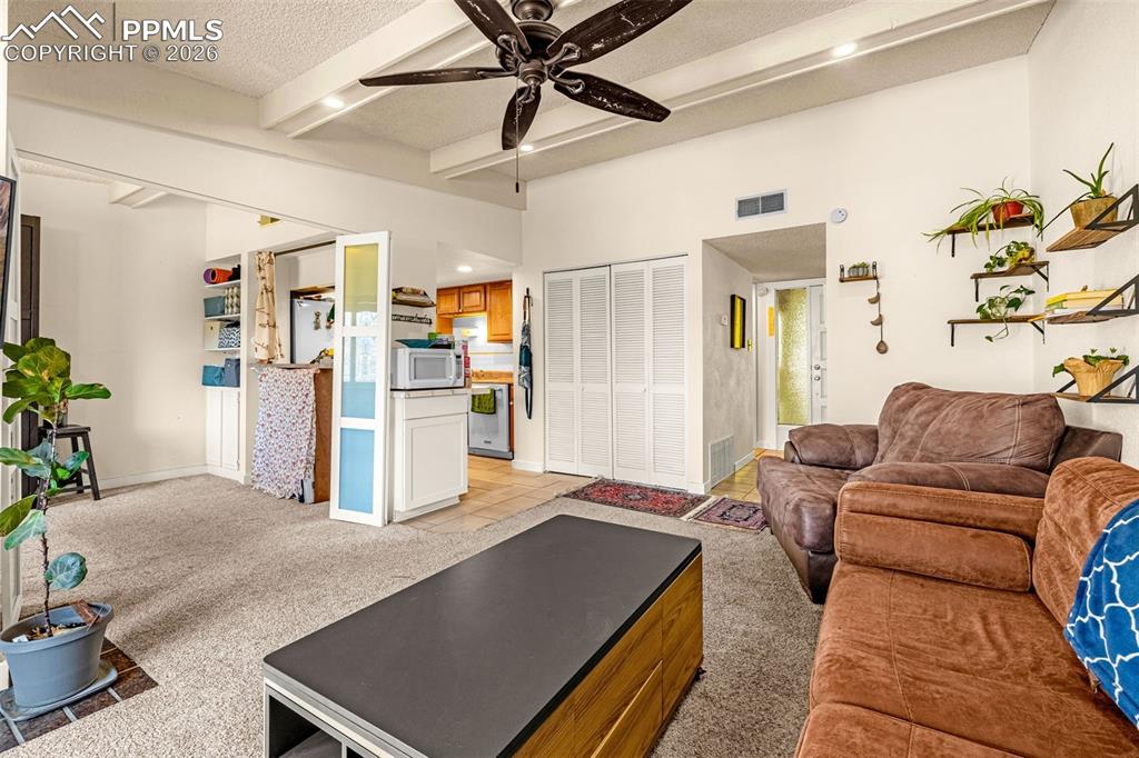 1018 Fontmore Road, Unit C Colorado Springs, CO 80904 - Photo 11 of 29 Living room with light carpet, beamed ceiling, ceiling fan, a textured ceiling, and recessed lighting