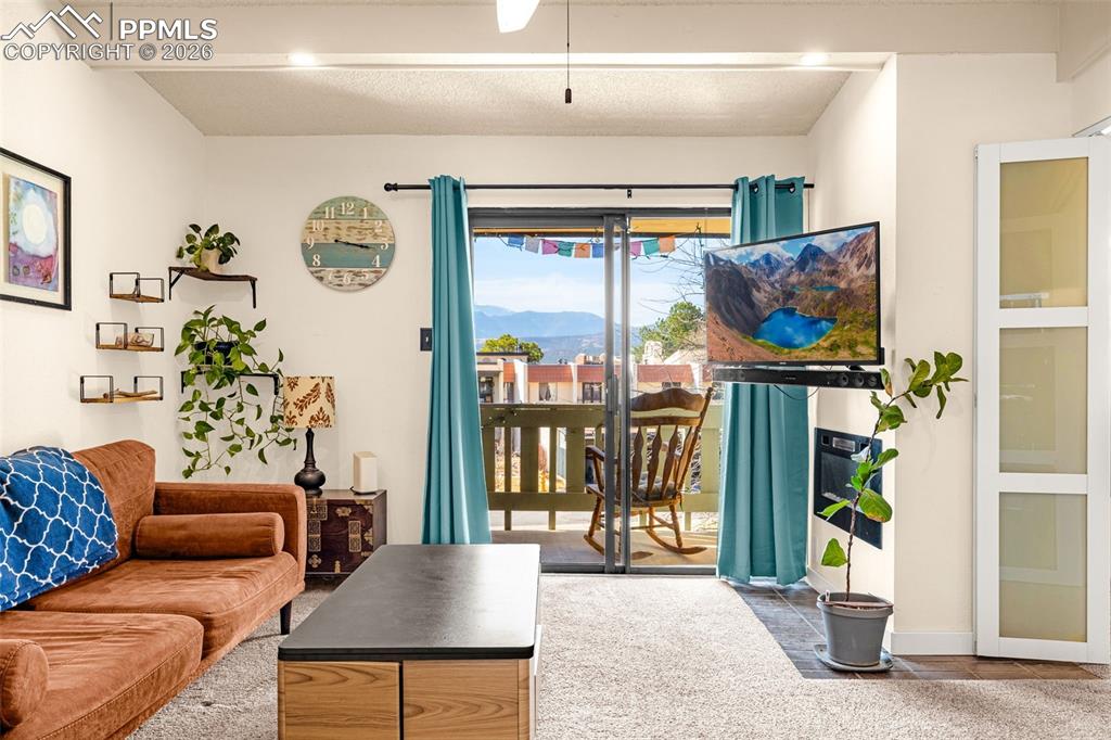 1018 Fontmore Road, Unit C Colorado Springs, CO 80904 - Photo 9 of 29 Living room featuring beam ceiling and baseboards