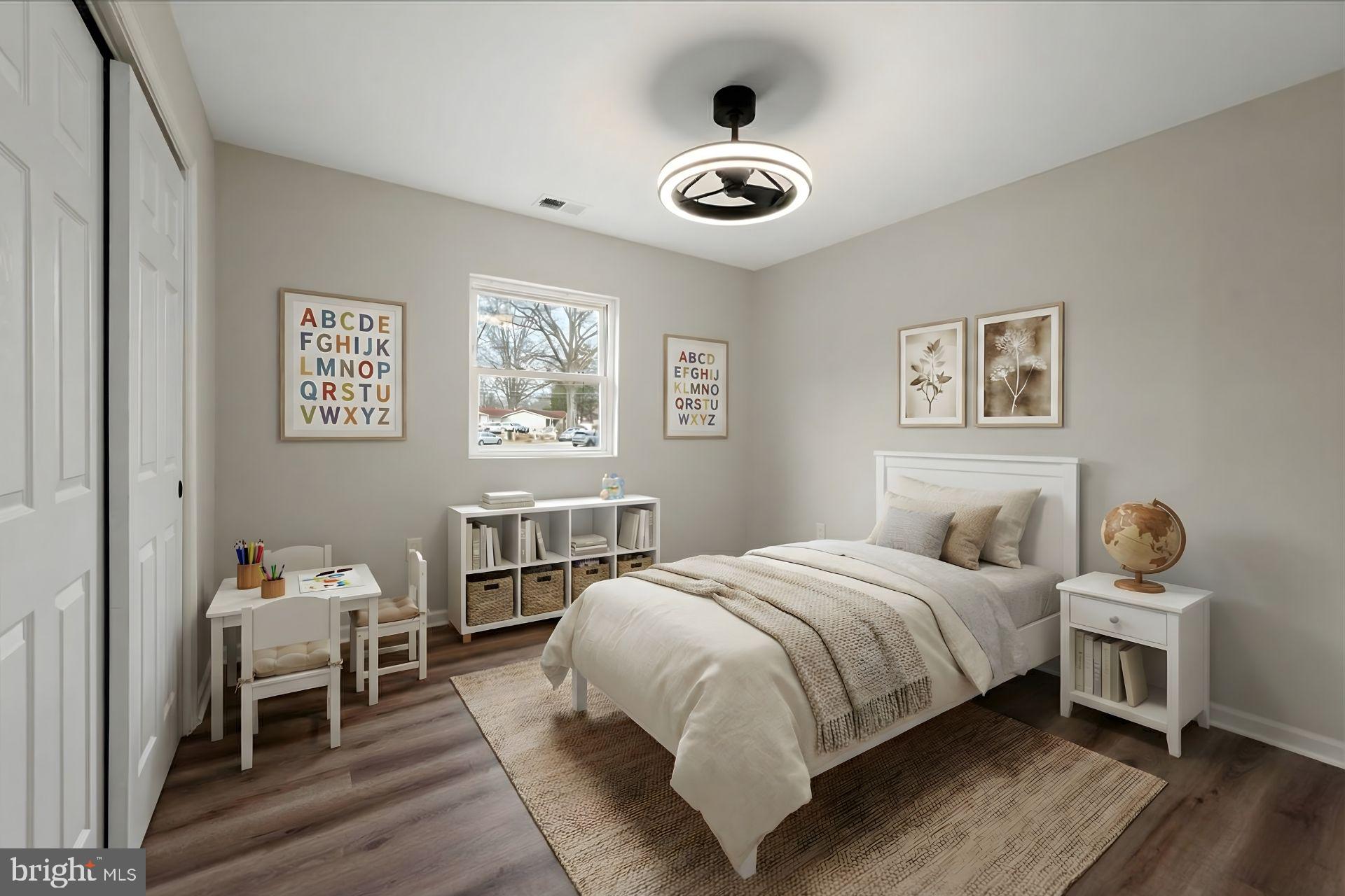 7931 Russell Road Alexandria, VA 22309 - Photo 12 of 16 a bedroom with a bed and wooden floor