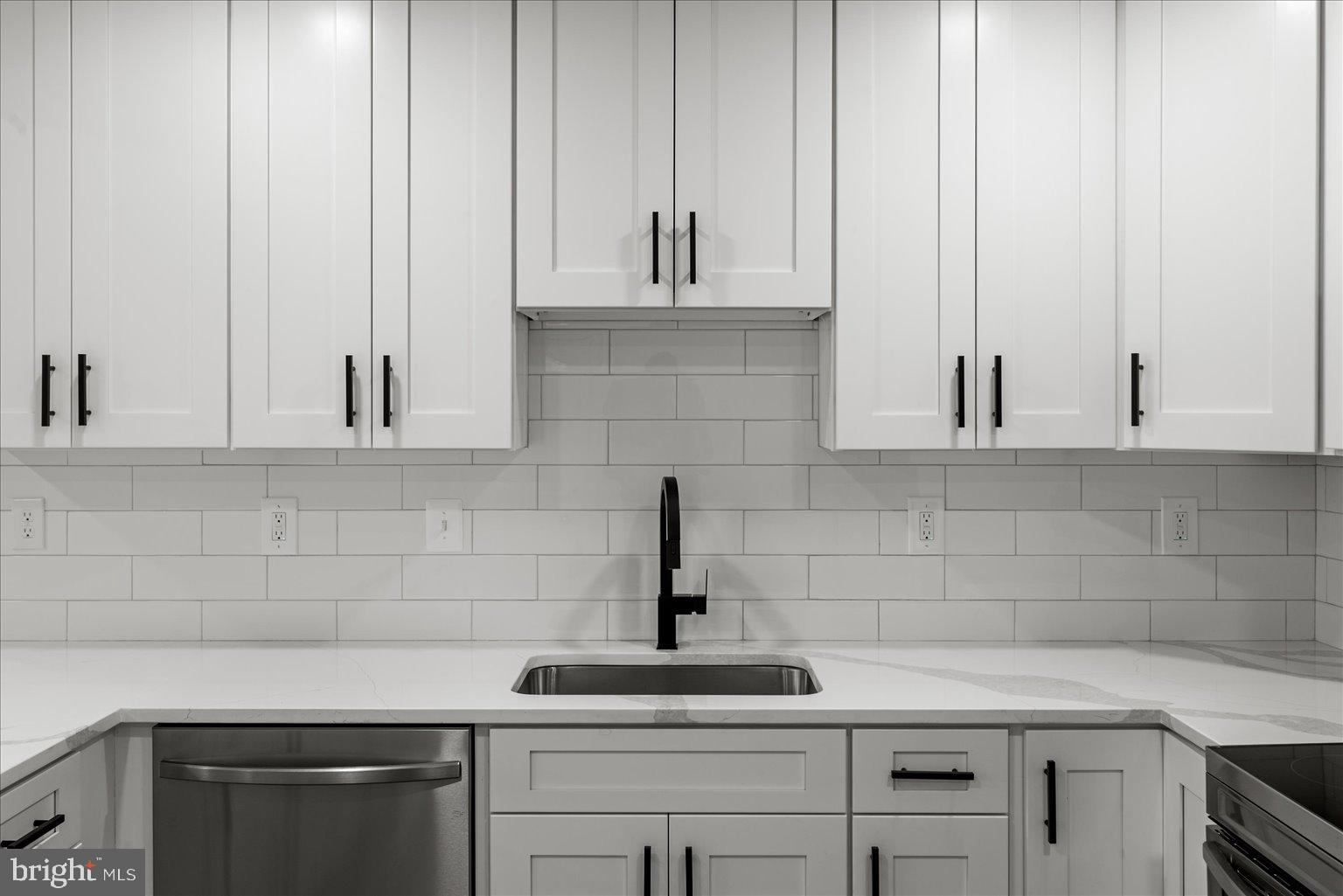 7931 Russell Road Alexandria, VA 22309 - Photo 4 of 16 a kitchen with white cabinets and a sink