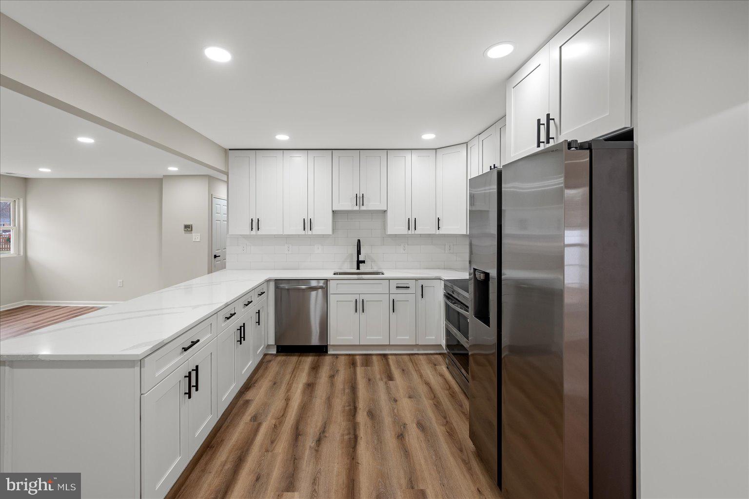 7931 Russell Road Alexandria, VA 22309 - Photo 5 of 16 a kitchen with white cabinets stainless steel appliances and a island
