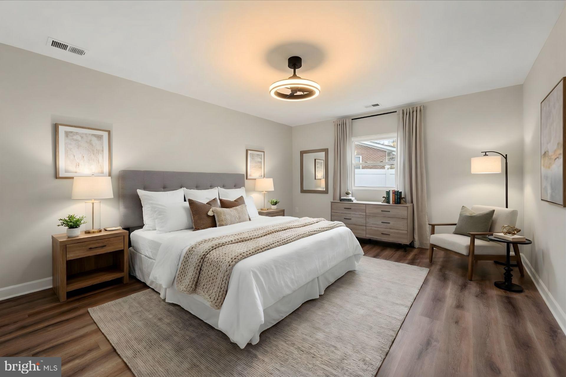 7931 Russell Road Alexandria, VA 22309 - Photo 7 of 16 a spacious bedroom with a bed and a chandelier