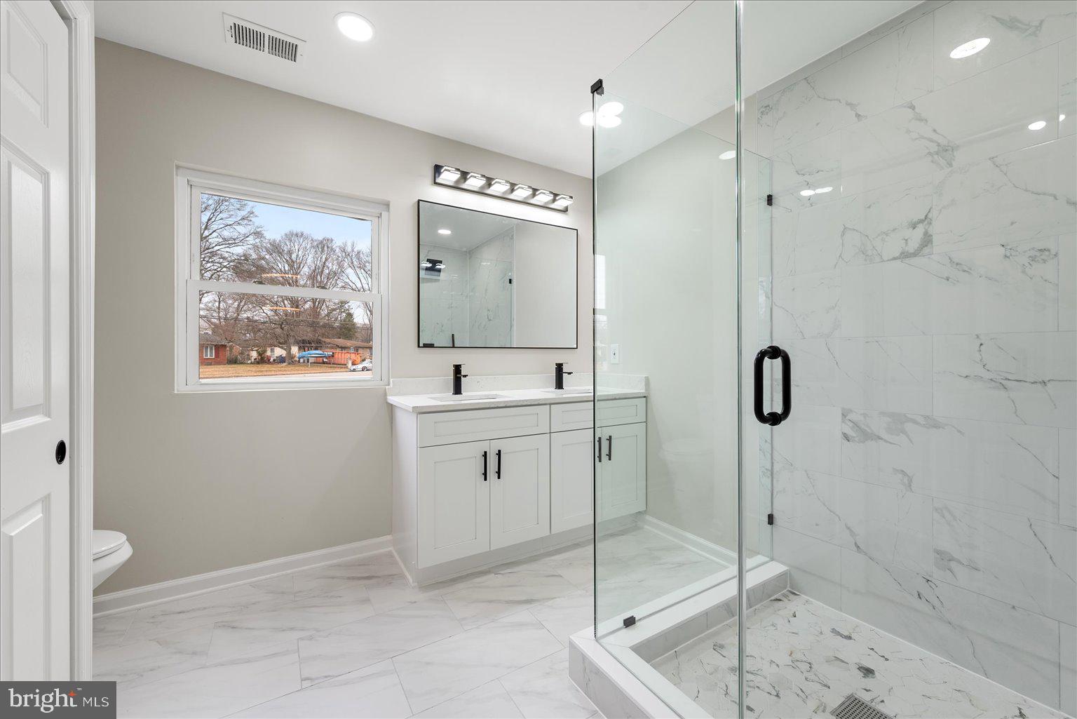 7931 Russell Road Alexandria, VA 22309 - Photo 8 of 16 a bathroom with a shower sink and mirror