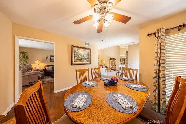 a dining room with furniture and wooden floor