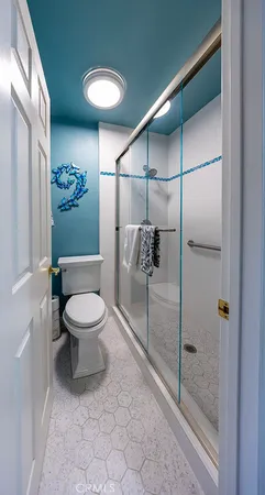 a bathroom with a toilet and a shower