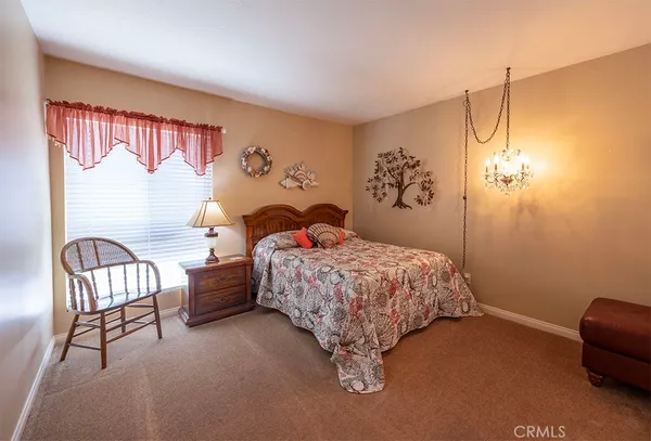a bedroom with a bed and a chair